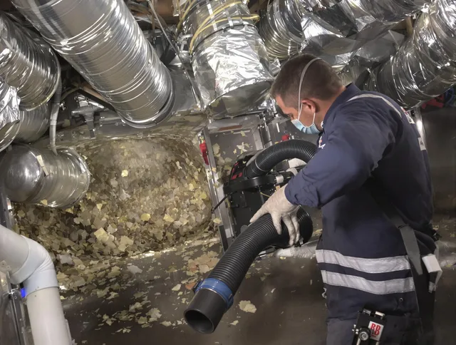 Uxbridge Air Duct Cleaning specialist operating negative pressure cleaning equipment for thorough duct maintenance in Uxbridge